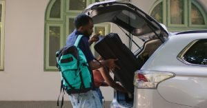 individual helping with someone’s luggage